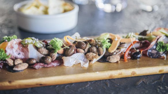 The deli board features four house-cured meats.