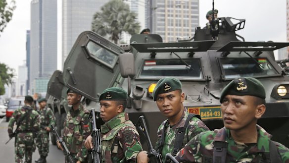 Indonesian soldiers stand guard in Central Jakarta, Indonesia on Thursday.