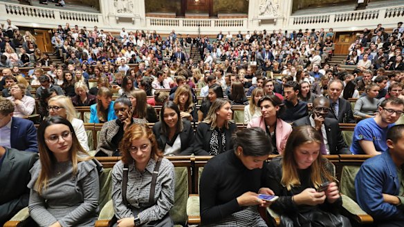 Members of the audience are pictured prior to the start of the French President's speech at the Sorbonne.
