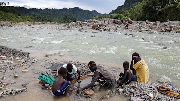 A family panning gold in the polluted Jaba river flowing from Panguna copper mine.
