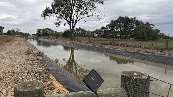 An irrigation canal with a solar-powered monitoring device, near Tatura in Victoria's Goulburn Valley.
