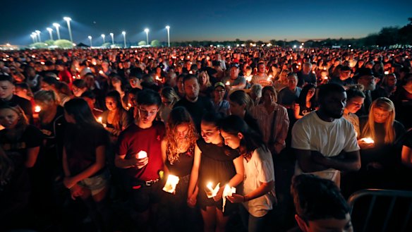 People attend a candlelight vigil for the victims of the Wednesday shooting at Marjory Stoneman Douglas High School, in Florida.