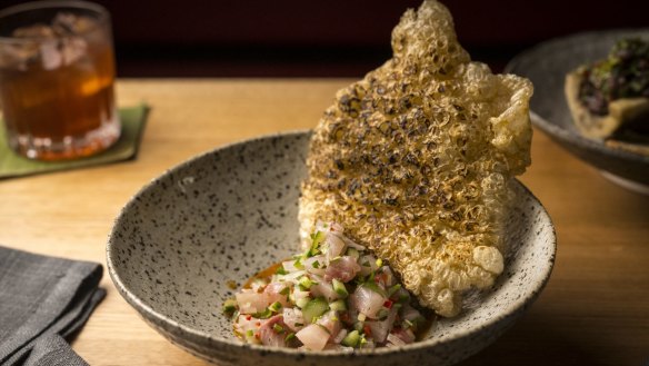 Sinuglaw made with raw kingfish, mixed with charred cucumber and fermented coconut, and served with a chicharron (deep-fried crackling).