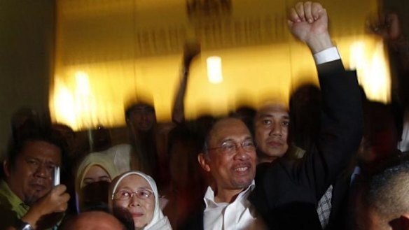Defiant: Anwar Ibrahim and his wife, Wan Azizah, leave court after his sodomy conviction was restored. He said the verdict was "choreographed" by Malaysia's Prime Minister.