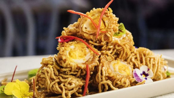 Deep-fried quail egg wrapped with egg noodle.