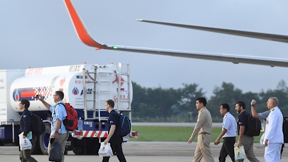Richard Harris, second from left, and Australian support staff board an Australian RAAF plane bound for Canberra, in Chiang Rai, Northern Thailand. 