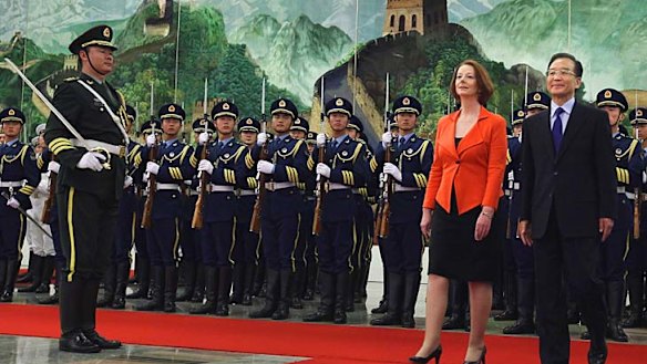 Dialogue... the Prime Minister, Julia Gillard, and the Chinese Premier, Wen Jiabao, view an honour guard during a welcoming ceremony in Beijing yesterday.