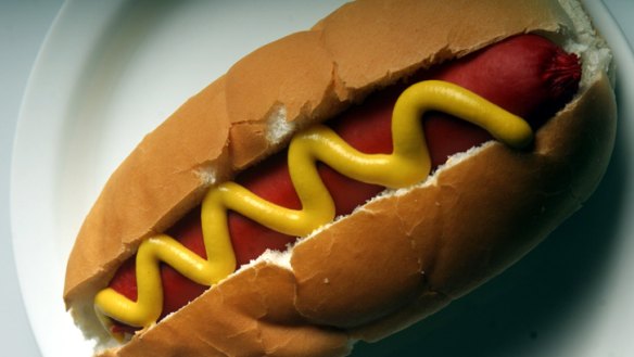 A squiggle of French's mustard on a classic hotdog.