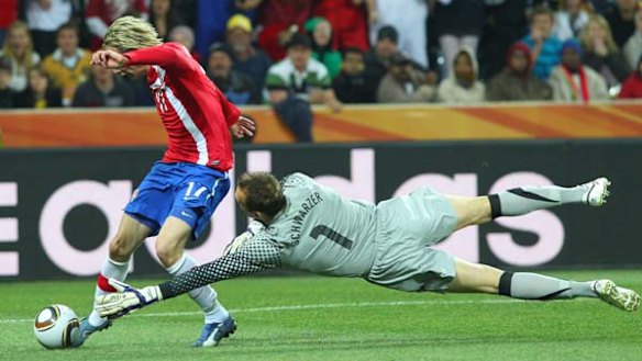 Close call ... Mark Schwarzer forces Serbia's Milos Krasic wide.