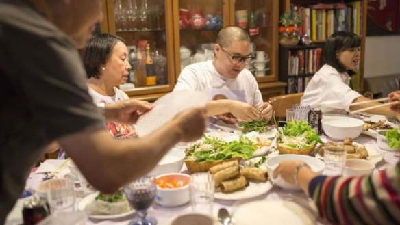 Around the table: Dan Hong, with his mother, Angie, on his left.