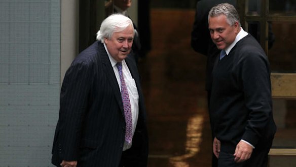 Palmer United Party leader Clive Palmer and Treasurer Joe Hockey depart after the Carbon Tax Repeal Bill passes the lower house. Photo: Alex Ellinghausen