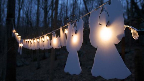 In heaven: Glowing angels hang from trees a month after 20 children and six staff members were killed at Sandy Hook elementary school.