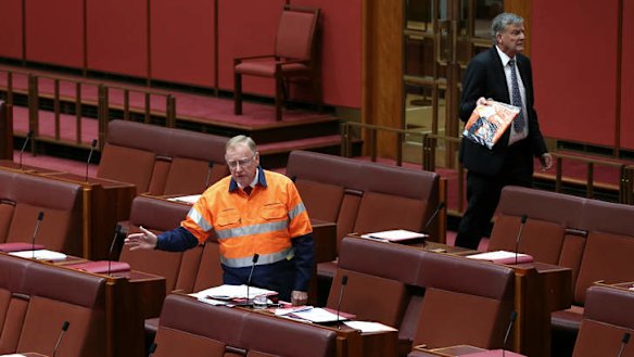 Liberal Senator Ian Macdonald speaks on the mining tax repeal as Bill Heffernan storms off. Photo: Alex Ellinghausen