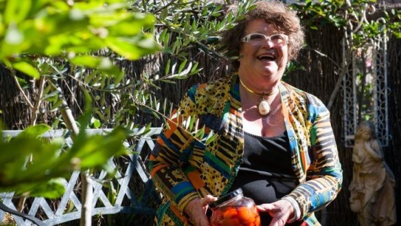 Passionate grower and cook Bronwyn Halbisch with a jar of her pickled quince in her Pearce garden.