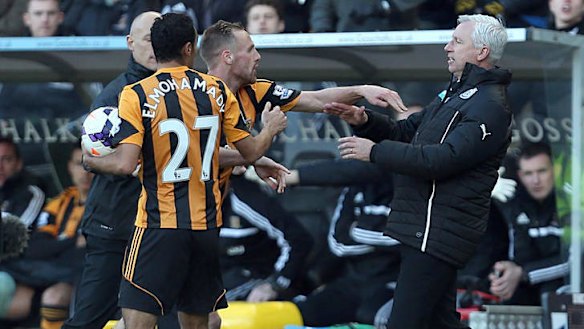 Newcastle United's manager Alan Pardew,  right,  and Hull City's David Meyler confront each other during the English Premier League match at the KC Stadium.