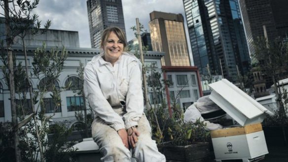 Vanessa Kwiatkowski and Mat Lumalasi with their hives on top of Federation Square.
