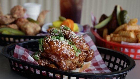 Sticky chicken ribs, wings, fries and pickles at Belles Hot Chicken pop-up.