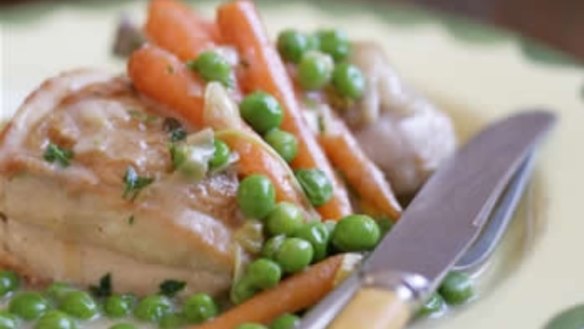 Chicken fricassee in white sauce with peas and carrots