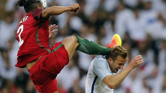 Red mist: Bruno Alves challenges Harry Kane at head height.