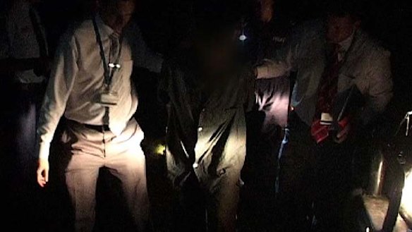 Caught ... Malcolm Naden is taken away by police.