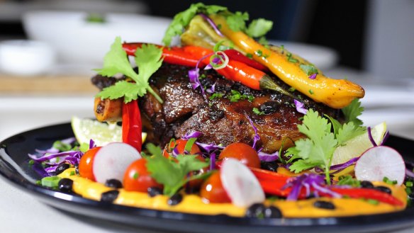 Chipotle, ancho chilli and cumin lamb: a roasted whole lamb shoulder served with sweet potato puree, turtle beans, rosemary kipflers and banana chillis.