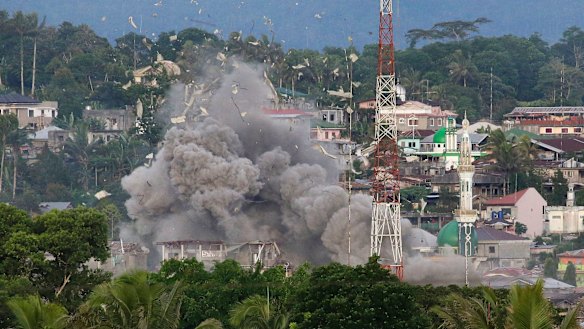 Debris flies as the Philippine Air Force bomb suspected locations of Muslim militants in Marawi Cty. 