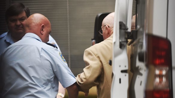 Roger Rogerson being led into the Supreme Court in Sydney on Monday.