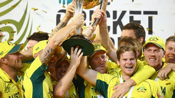 The Australian team cheer as they lift the World Cup trophy.