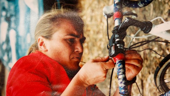 Helen, who was a keen cyclist, works on her bike. 