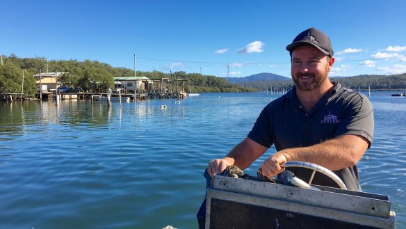 Oyster farmer Ben Ralston of Ralston Bros at the helm of his boat on the Clyde River at Batemans Bay.