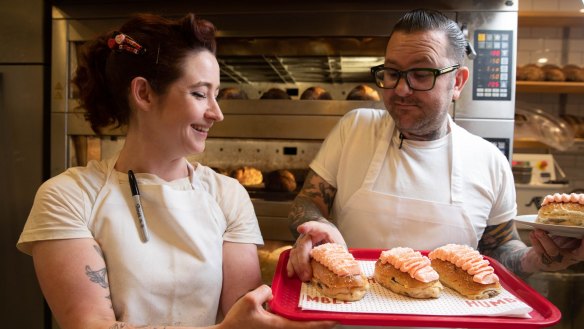 Ben Milgate and Alyce Bennett at Humble Bakery with a batch of fresh finger buns.