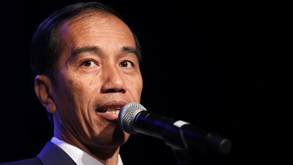 Members of Australia's Indonesian community listen intently to a speech by visiting Indonesian Presidednt, Joko Widodo addressing the crowd at the Sydney Convention Centre.