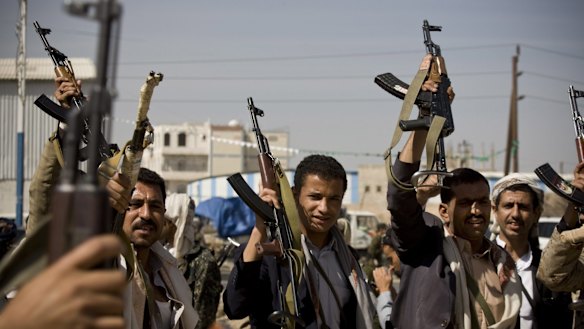 Houthi Shiite Yemeni raise their weapons near the presidential palace in Sanaa, Yemen.