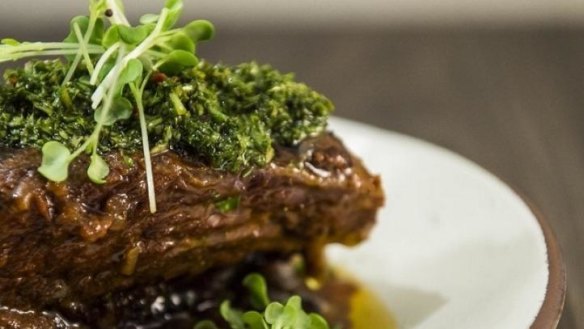 Twelve-hour slow-cooked beef short rib with black beans and chimichurri.