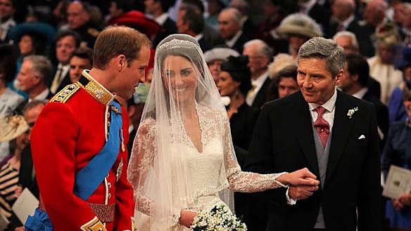 Relaxed ... Prince William stands at the altar with his bride, Kate Middleton, and her father Michael.