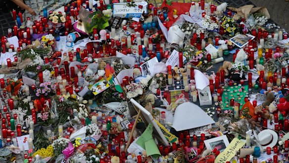 Flowers, messages and candles form a memorial tribute to the victims of terrorists.