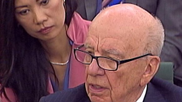 Out of touch ...  Rupert Murdoch answers a question as his wife Wendi Deng looks on.