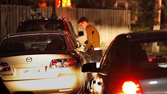 Senior Constable Katy Berger questions the driver of a car stopped  during the operation targeting gutter crawlers in the St Kilda area.