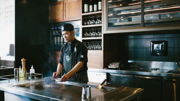 Chef Eric Chan prepares beef at Vic's Meat Market wagyu bar.