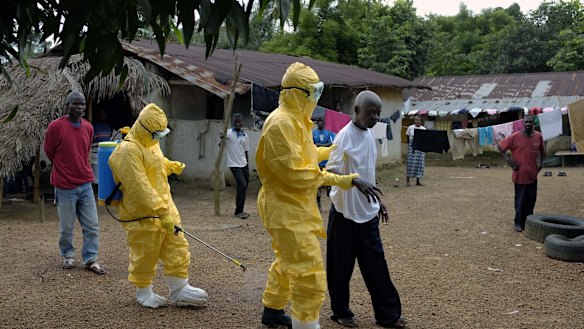 Yarkpawoto Paye, 84, is taken to an ambulance after showing signs of Ebola infection in the village of Freeman Reserve, about 50 kilometres north of Monrovia, Liberia.