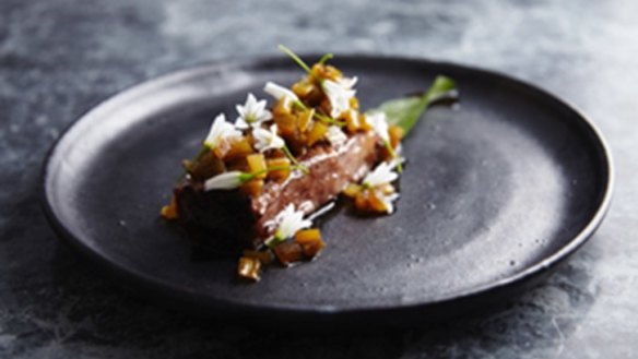 Beef short rib with roasted celery vinaigrette and garlic flowers.