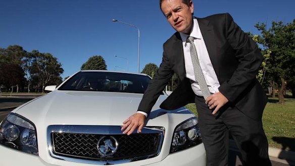 Opposition Leader Bill Shorten gets into his Holden COMCAR on his arrival in Canberra. Photo: Alex Ellinghausen