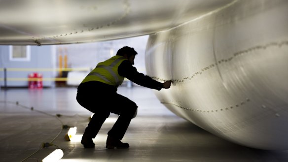 A worker inspects the skin of the hull of the Airlander 10.