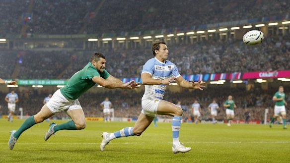 Flyer: Argentina's Juan Imhoff, right, races clear of Ireland's Rob Kearney before catching the ball to score.