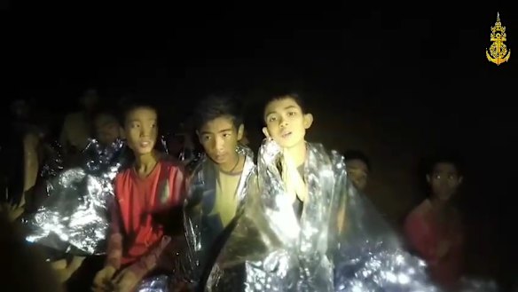 Some of the trapped boys praying in the cave in Tham Luang.