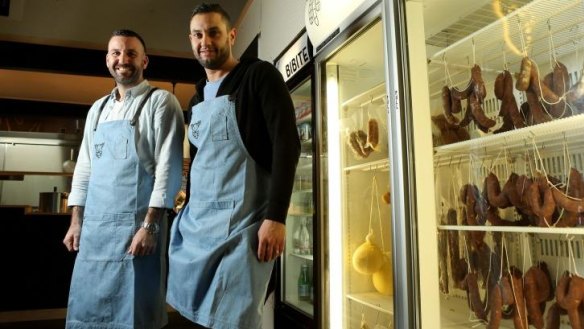 Frank Bressi (left) and Peter Mastro with their salumi fridge.