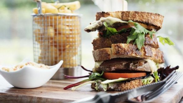 A steak sandwich with chips.