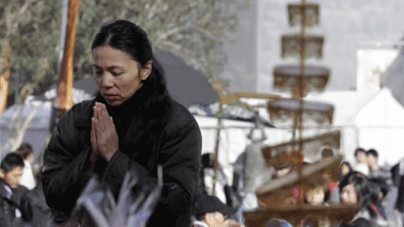 MELBOURNE, AUSTRALIA-MAY 16,2010 Photo of People offering prayers during Buddha's Day and Multicultural Festival at Melbourne s Federation Square on Sunday May 16, 2010.