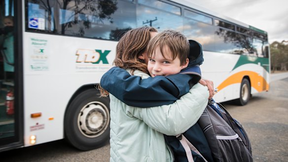 Timothy Pengilly hugs his mother Roz after getting off the school bus near his Murrumbateman home. He makes the long commute to Canberra every school day. 