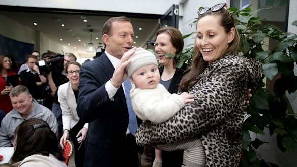 Motherhood statement: Tony Abbott and Liberal MP Kelly O'Dwyer meet Amelia Taylor and five-month-old Thomas at a Malvern cafe on Sunday.